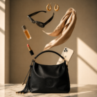 Zynara Fashion luxury black handbag with quilted design, tassel detail, and shoulder strap on marble surface with accessories