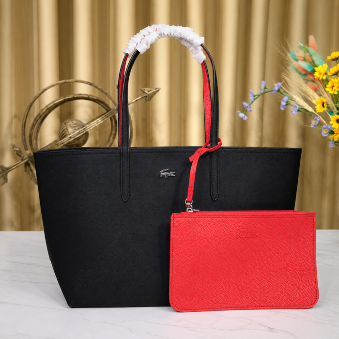 Lacoste black red tote bag showing the red reversible side