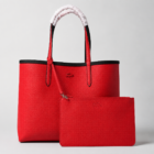 Lacoste black red tote bag showing the red reversible side